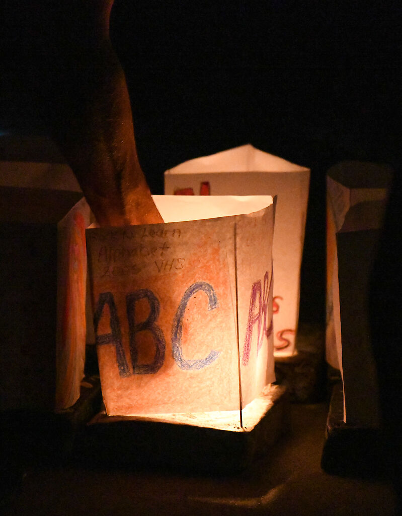 Participants light lanterns